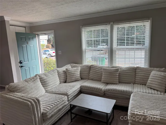 a bedroom with a couch and a window