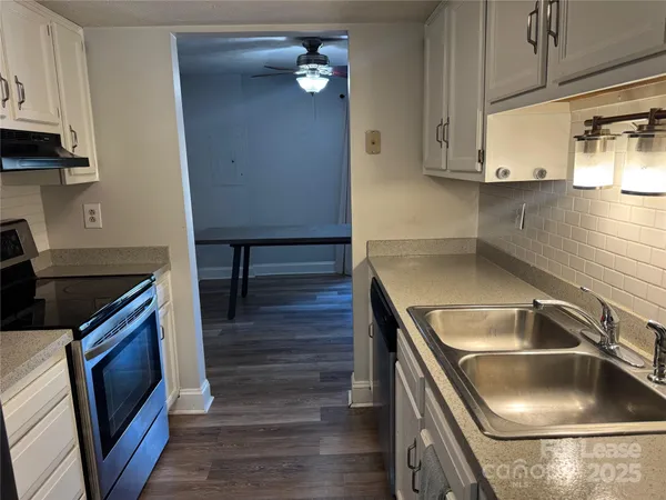 a kitchen with kitchen island a sink appliances and cabinets