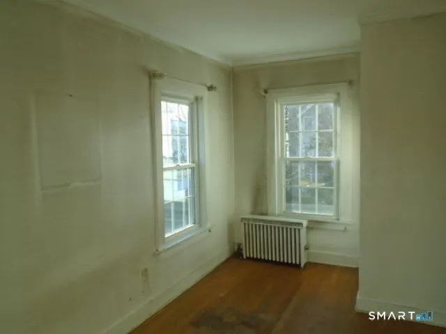 a view of an empty room and a window