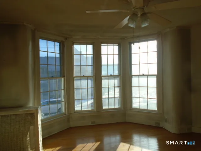 an empty room with windows and entrance