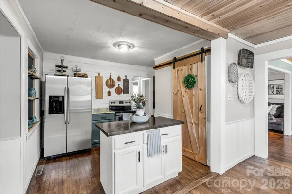 a kitchen with stainless steel appliances a refrigerator and a stove