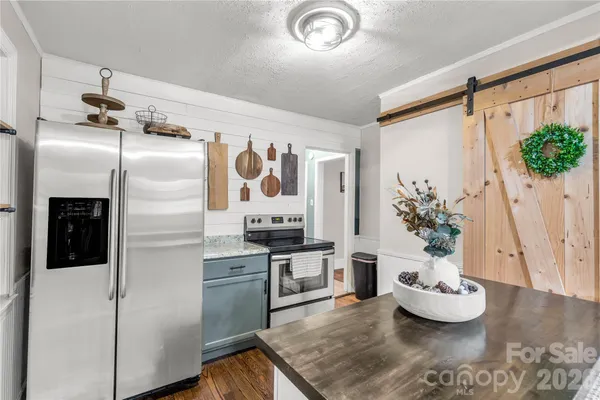 a kitchen with stainless steel appliances a refrigerator and a stove