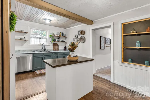 a kitchen with granite countertop a sink and cabinets