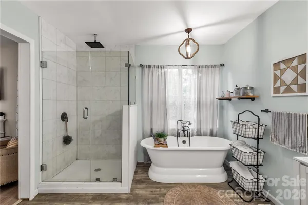 a bathroom with a bathtub and a shower