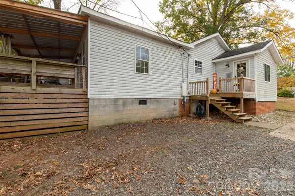 a backyard of a house with barbeque oven and table