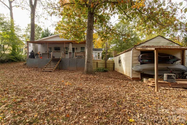 a backyard of a house with barbeque oven table and chairs
