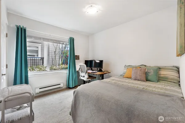 a bedroom with a bed and a large window