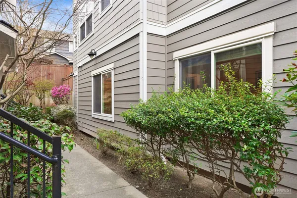 a front view of a house with plants
