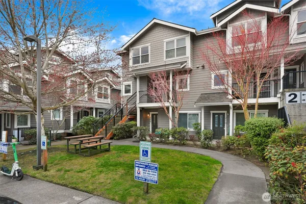 a front view of a residential apartment building with a yard