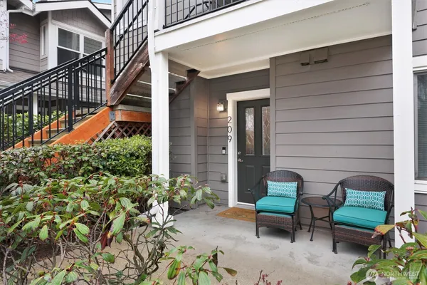 a backyard of a house with outdoor seating