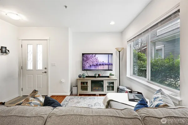 a living room with furniture a fireplace and a flat screen tv