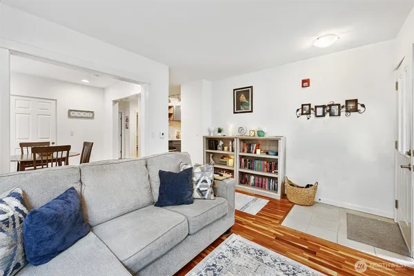 a living room with furniture and a book shelf
