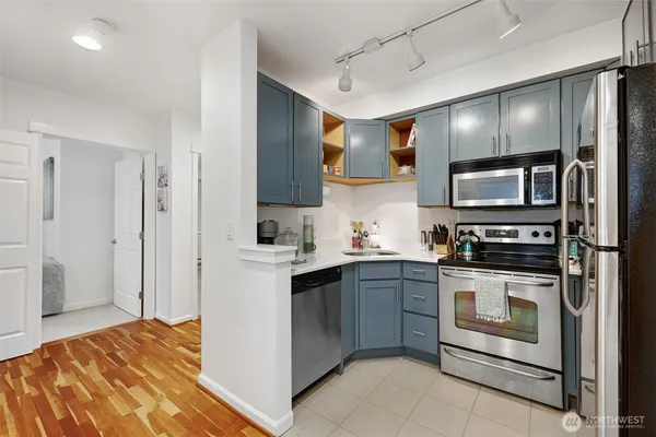 a kitchen with stainless steel appliances granite countertop a refrigerator and a stove top oven