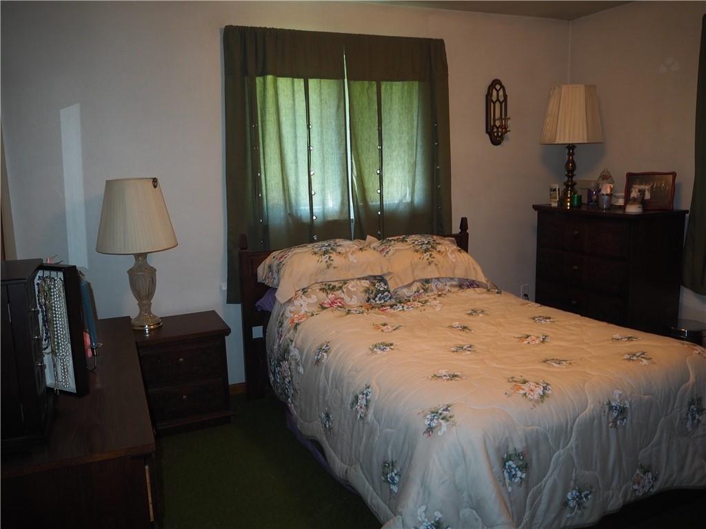 420 Saxonburg Road Butler, PA 16002 - Photo 14 of 26 a bedroom with a bed and a lamp on table