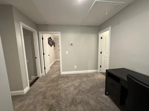 a bedroom with a bed and a ceiling fan