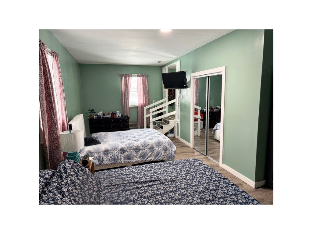 9 Alpha Street Haverhill, MA 01832 - Photo 12 of 14 a living room with a bed furniture and a flat screen tv