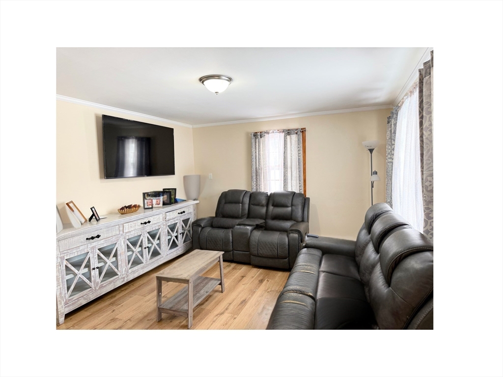 9 Alpha Street Haverhill, MA 01832 - Photo 3 of 14 a living room with furniture and a flat screen tv