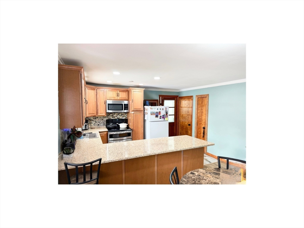 9 Alpha Street Haverhill, MA 01832 - Photo 5 of 14 a living room with furniture and a table