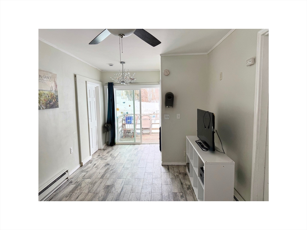 9 Alpha Street Haverhill, MA 01832 - Photo 7 of 14 a hallway with a computer on a table and a flat screen tv