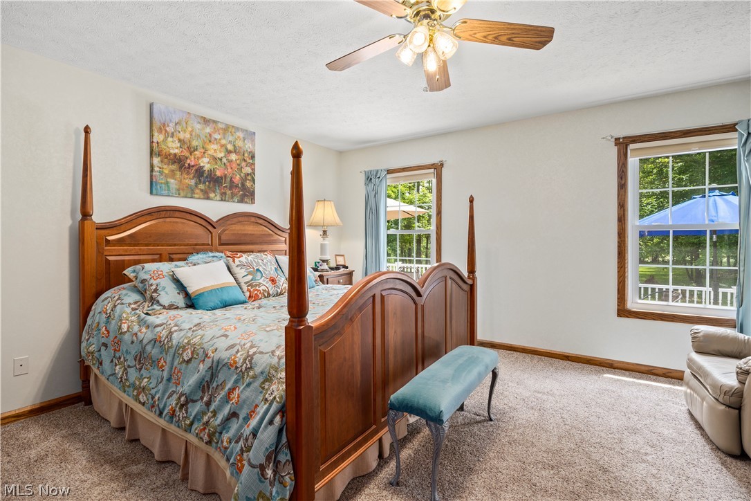 8737 River Corners Road Homerville, OH 44235 - Photo 22 of 46 Master Bedroomfeaturing ceiling fan and a textured ceiling