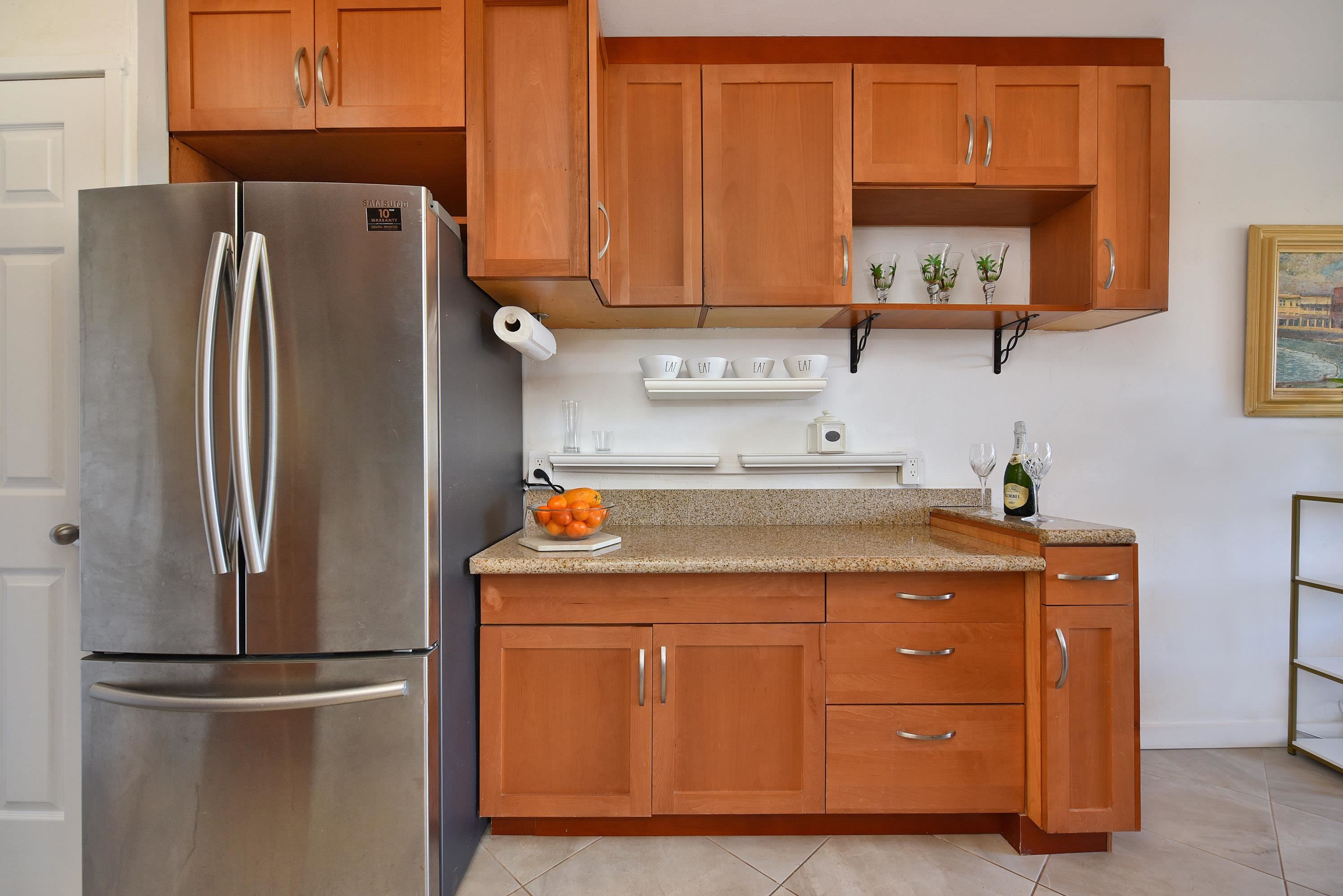 3660 Lower Honoapiilani Road, Unit 302 Lahaina, HI 96761 - Photo 12 of 27 a kitchen with stainless steel appliances granite countertop a refrigerator a stove and a sink