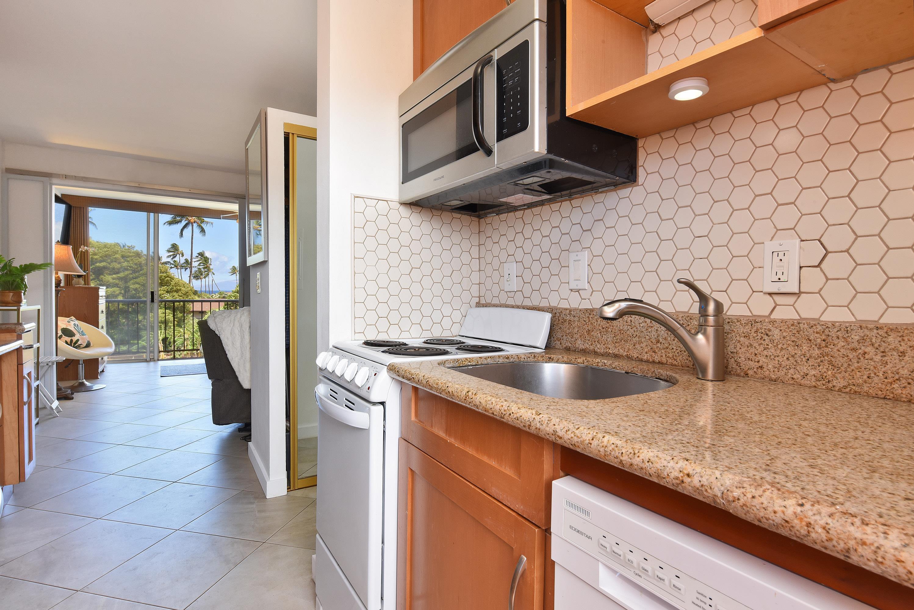 3660 Lower Honoapiilani Road, Unit 302 Lahaina, HI 96761 - Photo 14 of 27 a kitchen with stainless steel appliances granite countertop a sink and a stove