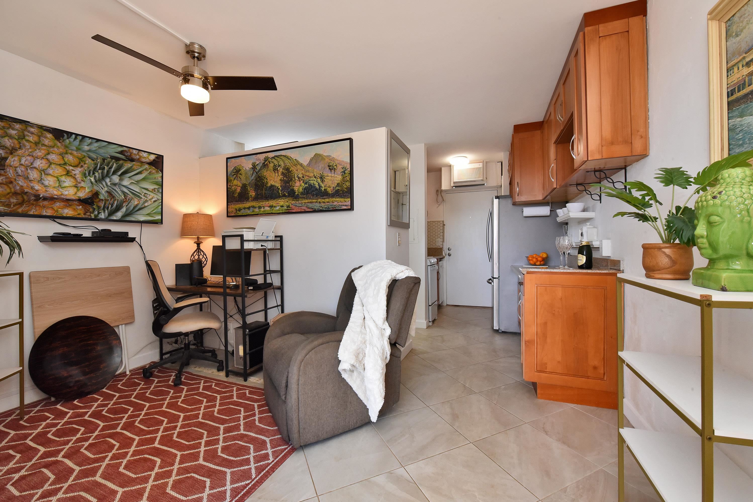 3660 Lower Honoapiilani Road, Unit 302 Lahaina, HI 96761 - Photo 17 of 27 a living room with furniture a flat screen tv and a fireplace