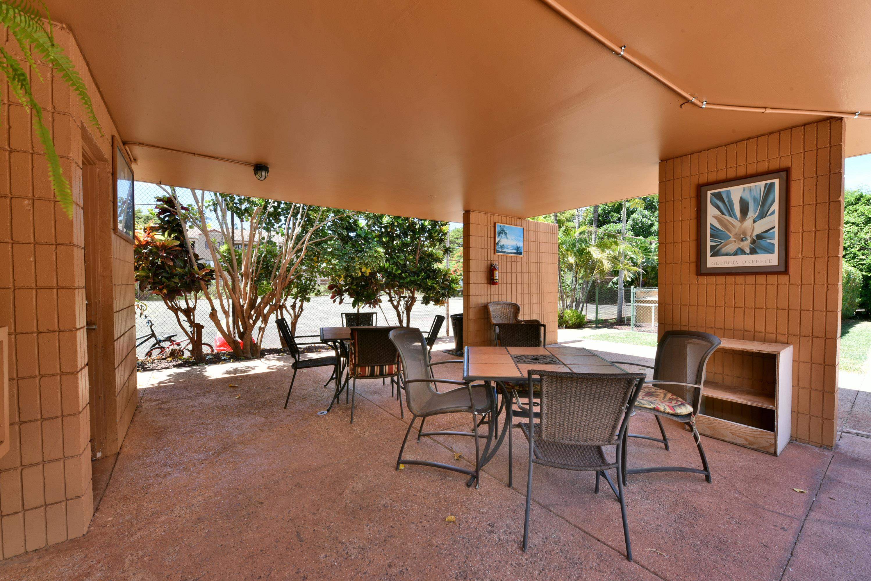 3660 Lower Honoapiilani Road, Unit 302 Lahaina, HI 96761 - Photo 20 of 27 a view of a patio with a table and chairs