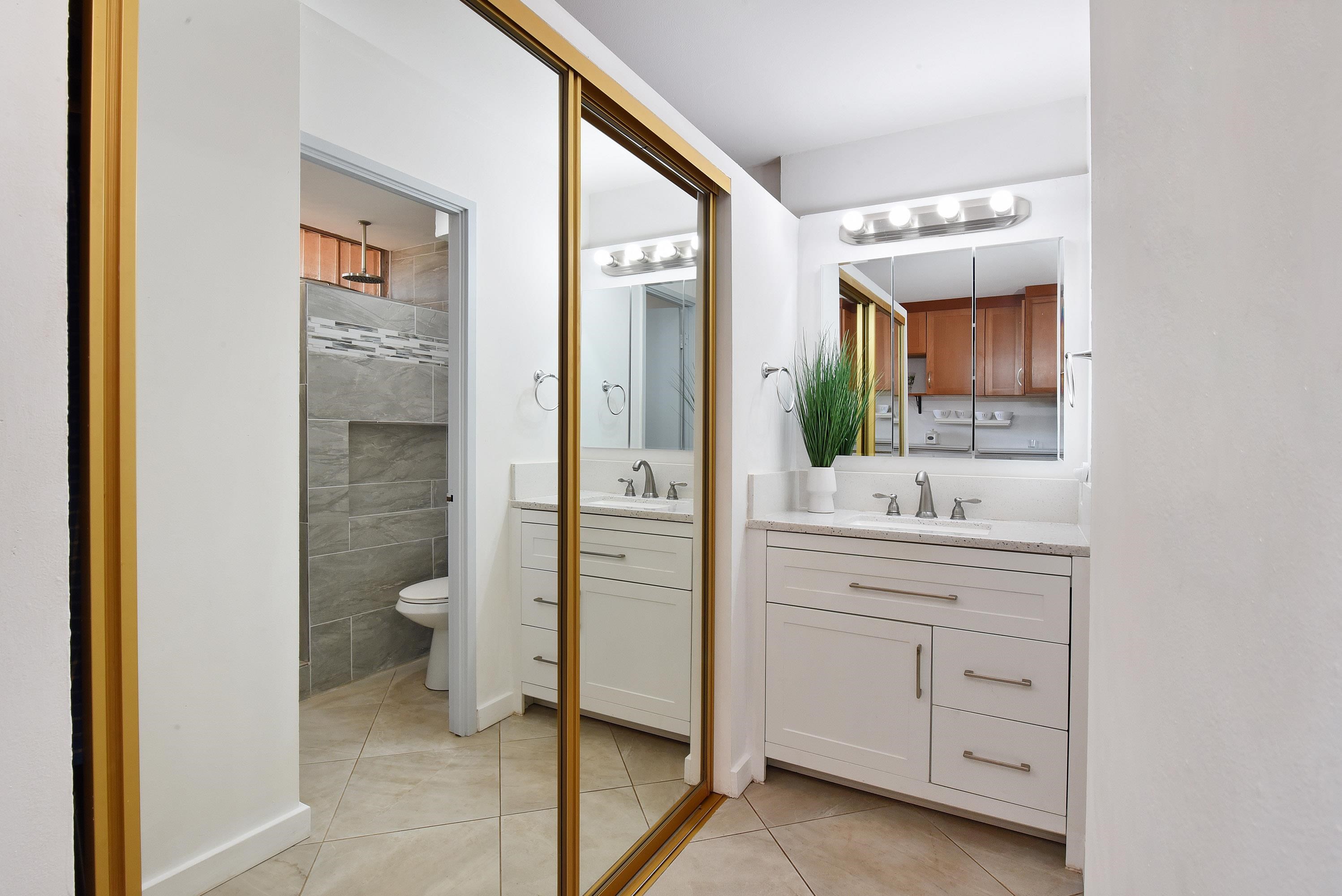 3660 Lower Honoapiilani Road, Unit 302 Lahaina, HI 96761 - Photo 2 of 27 a bathroom with a granite countertop sink mirror and toilet