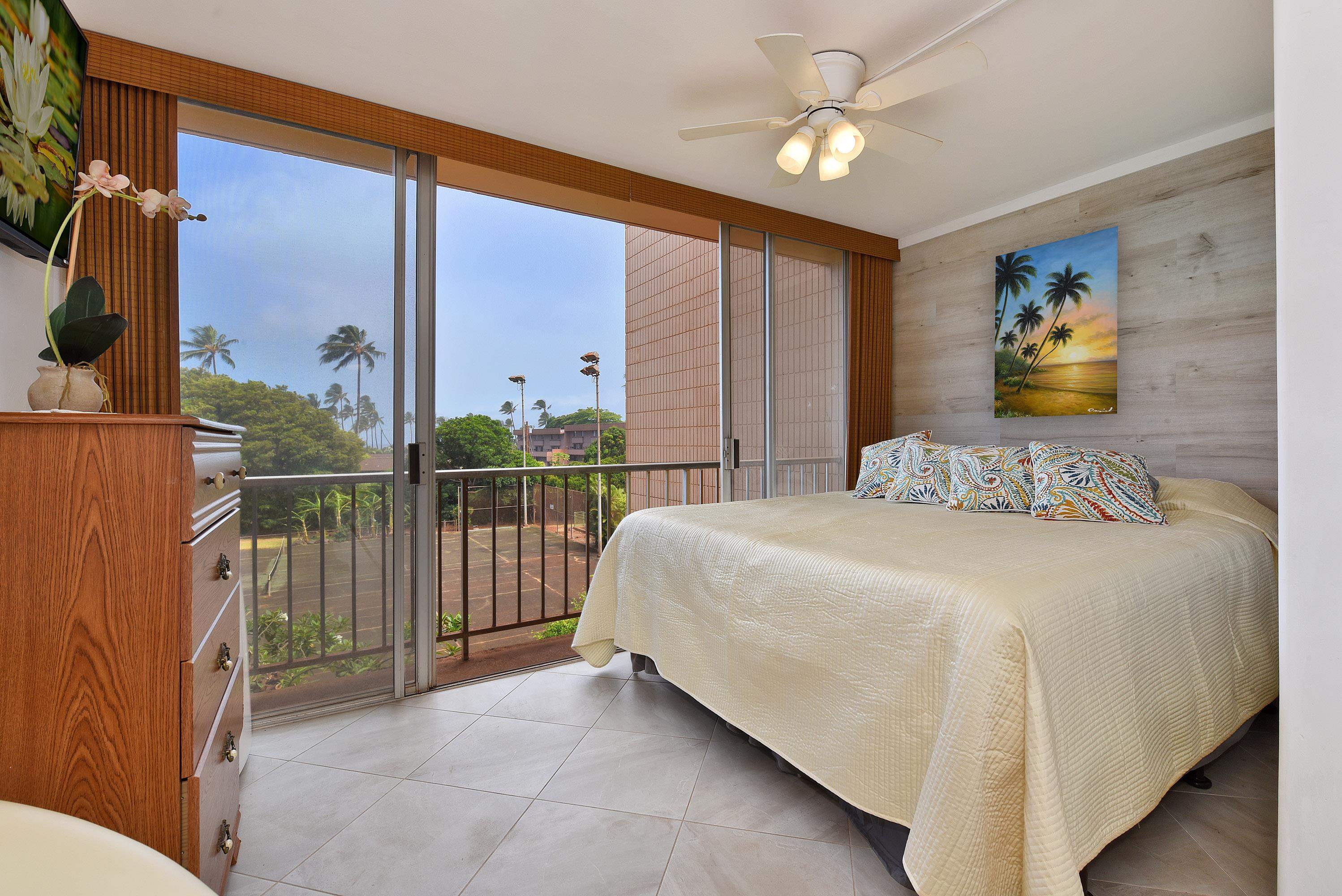 3660 Lower Honoapiilani Road, Unit 302 Lahaina, HI 96761 - Photo 7 of 27 a bedroom with a bed and a chandelier