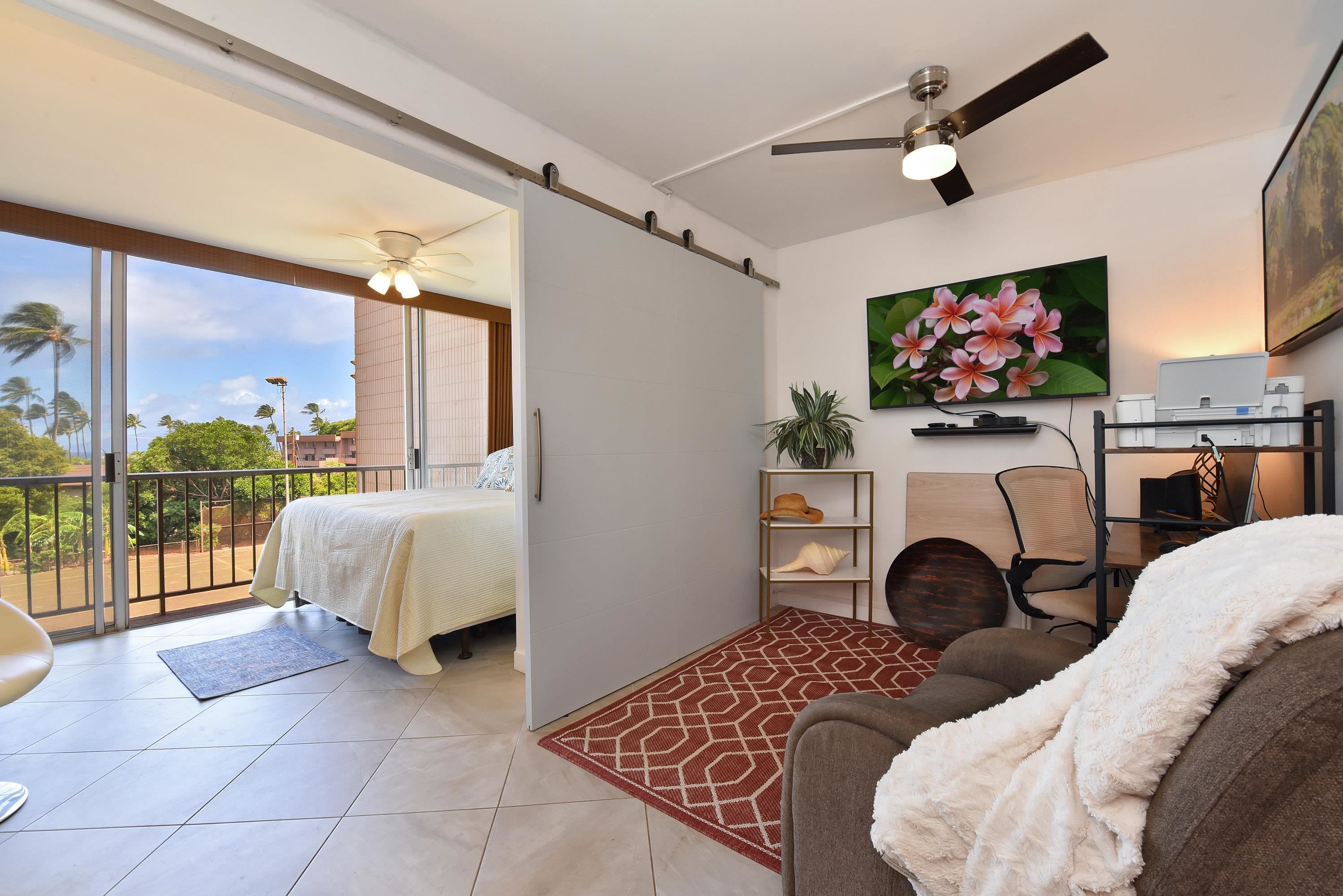 3660 Lower Honoapiilani Road, Unit 302 Lahaina, HI 96761 - Photo 10 of 27 a living room with furniture a flat screen tv and a fireplace