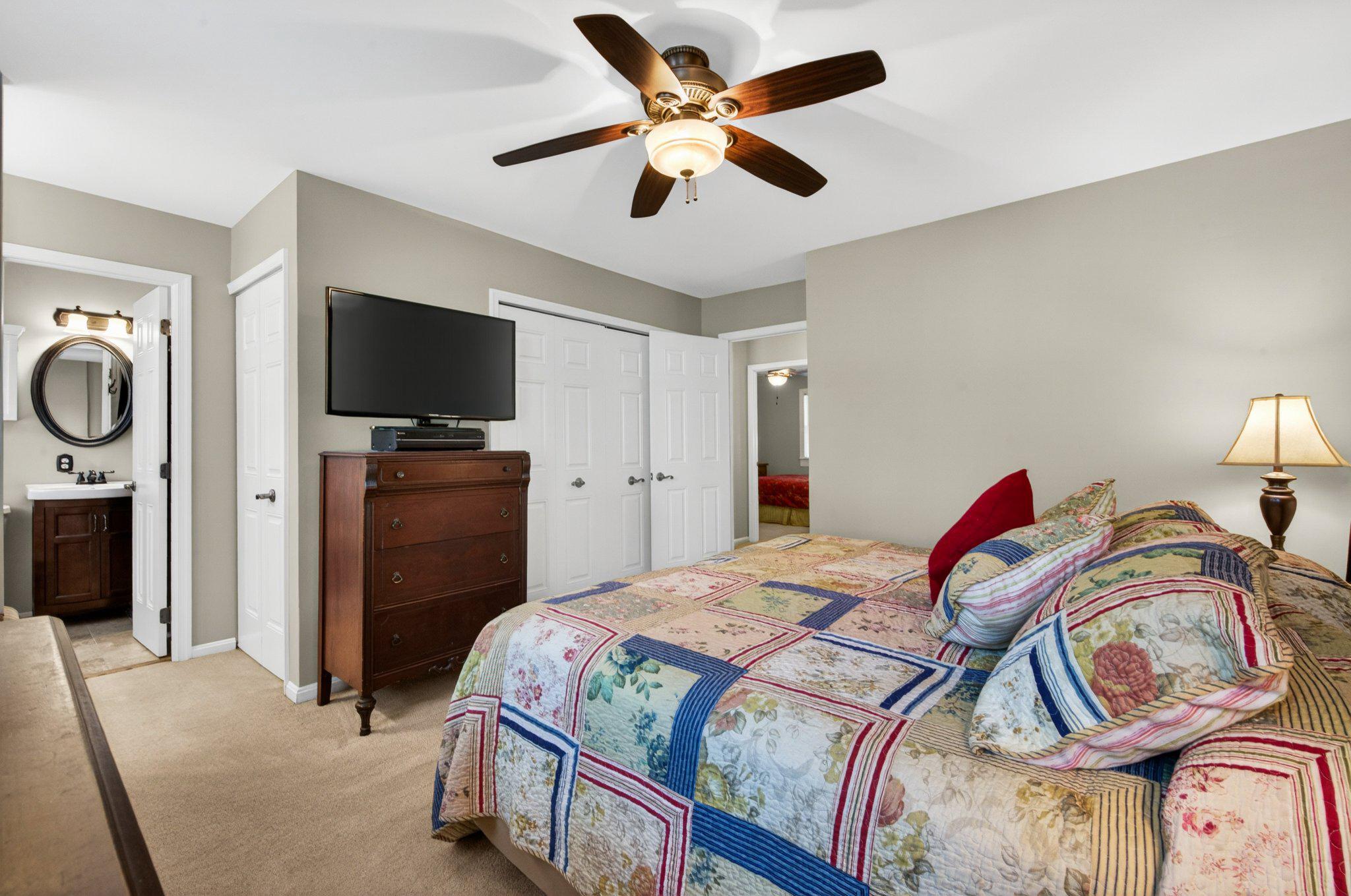 11737 Dry River Court Reston, VA 20191 - Photo 18 of 45 a bedroom with a bed and a flat screen tv