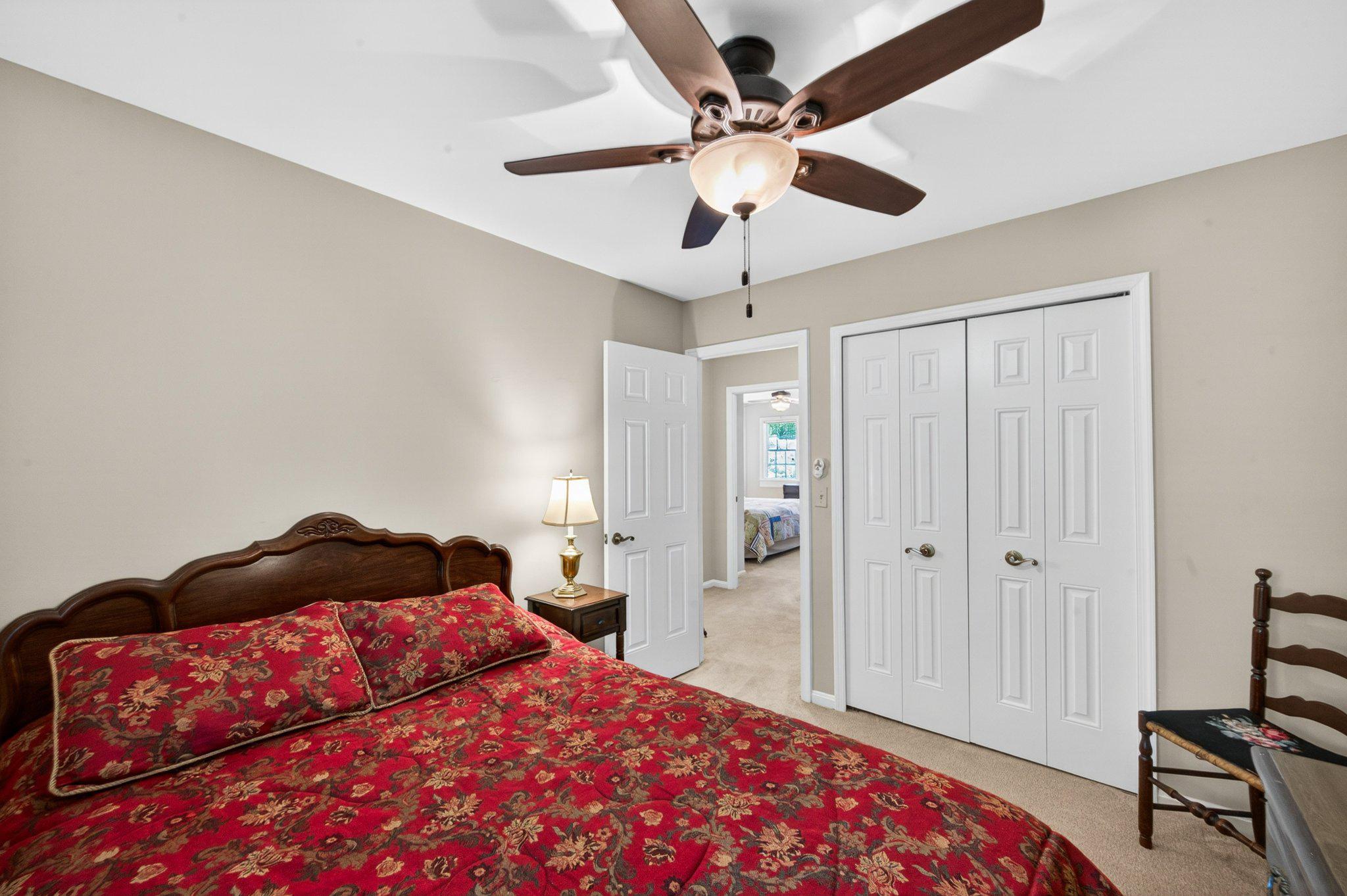 11737 Dry River Court Reston, VA 20191 - Photo 20 of 45 a bedroom with a large bed and a chandelier