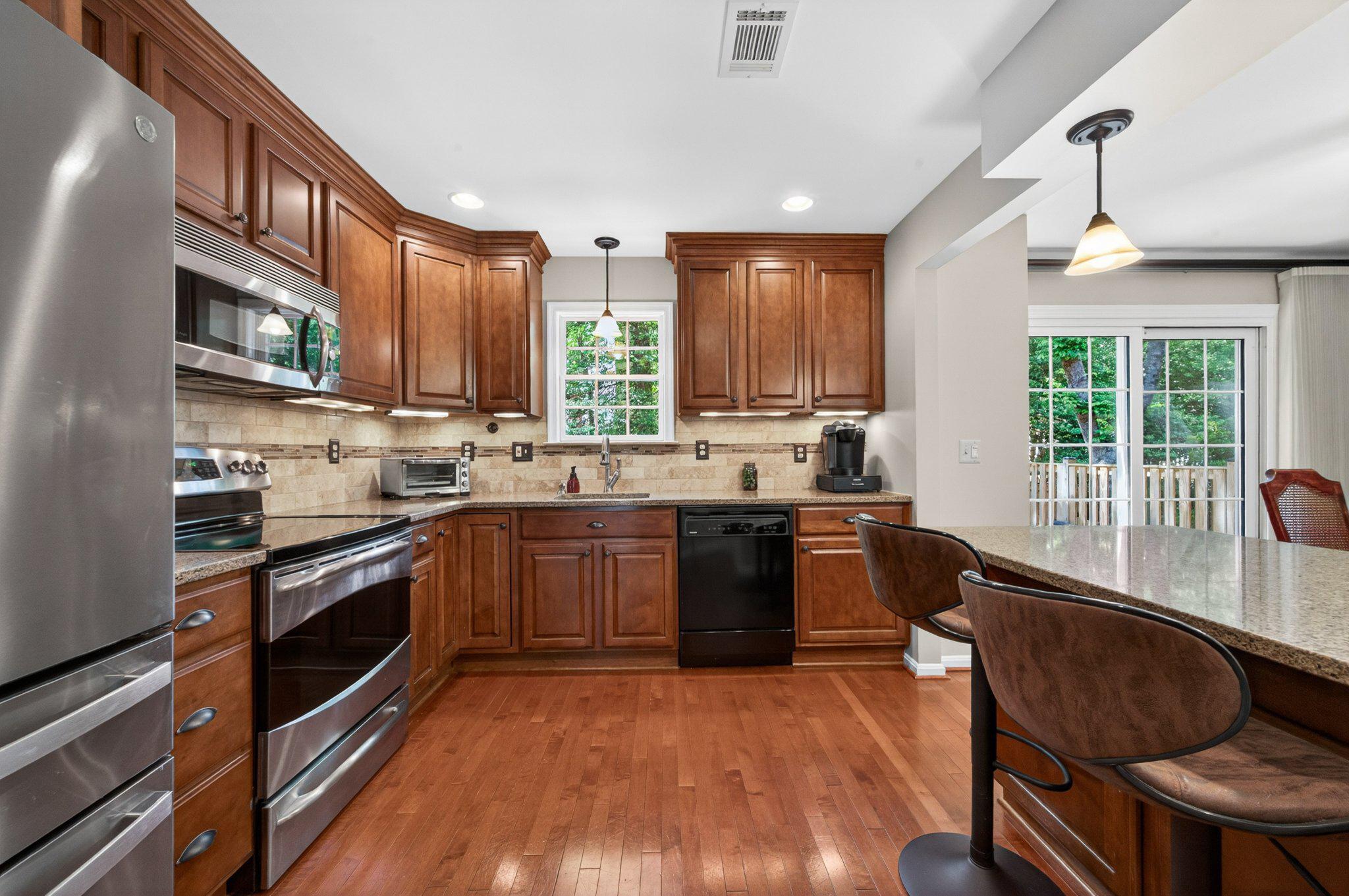 11737 Dry River Court Reston, VA 20191 - Photo 6 of 45 a kitchen with stainless steel appliances granite countertop a stove and a sink