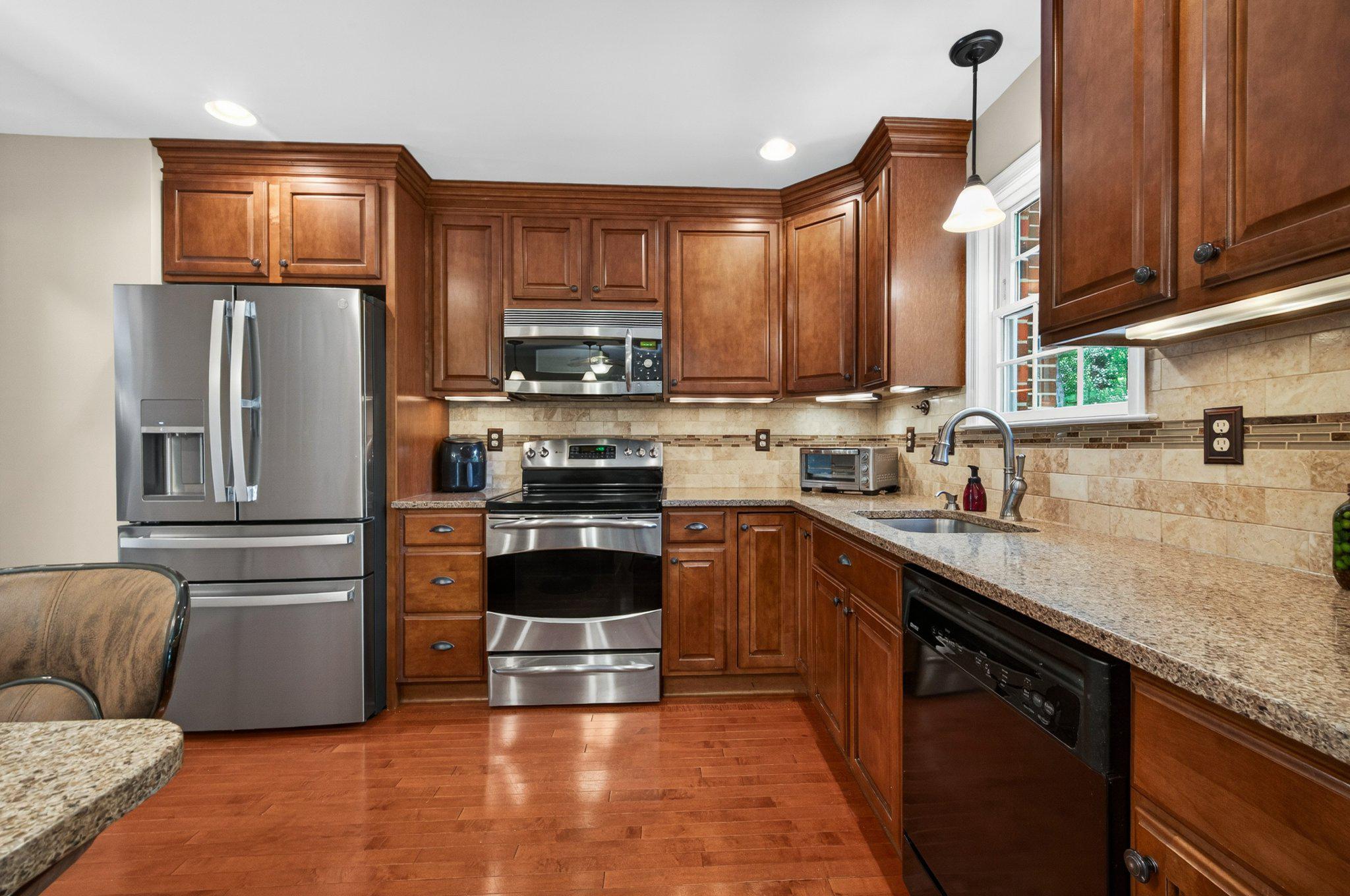 11737 Dry River Court Reston, VA 20191 - Photo 7 of 45 a kitchen with stainless steel appliances granite countertop a refrigerator sink and stove