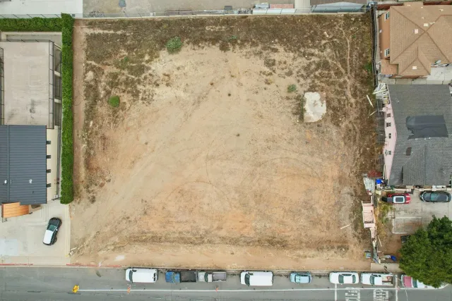 an aerial view of residential building with green space