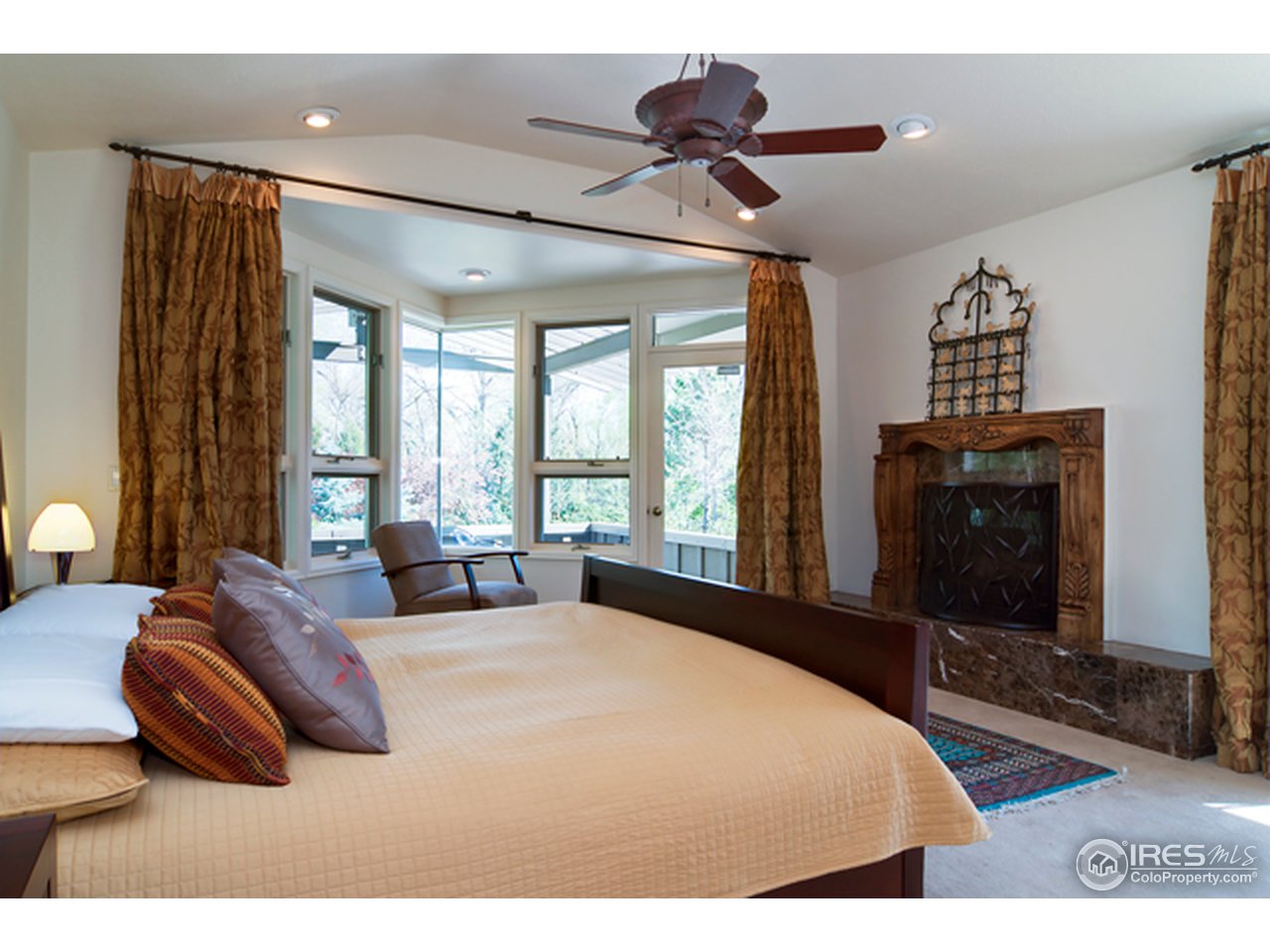 1270 Old Tale Road Boulder, CO 80303 - Photo 22 of 25 a bedroom with a bed and a flat tv screen