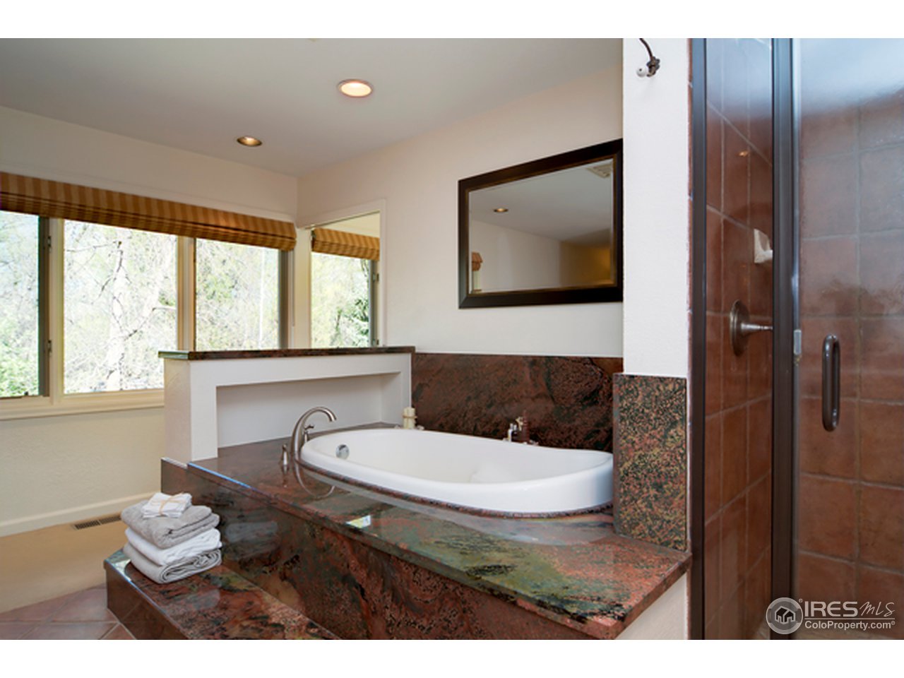 1270 Old Tale Road Boulder, CO 80303 - Photo 24 of 25 a bathroom with a toilet a sink and a mirror