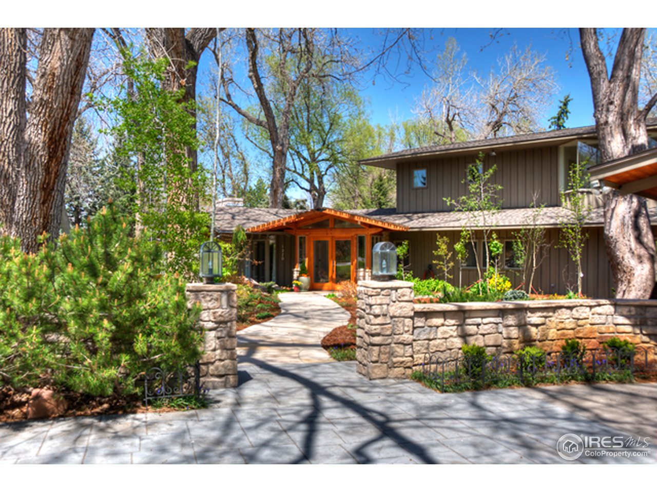 1270 Old Tale Road Boulder, CO 80303 - Photo 3 of 25 a view of a patio with table and chairs under an umbrella with a fire pit