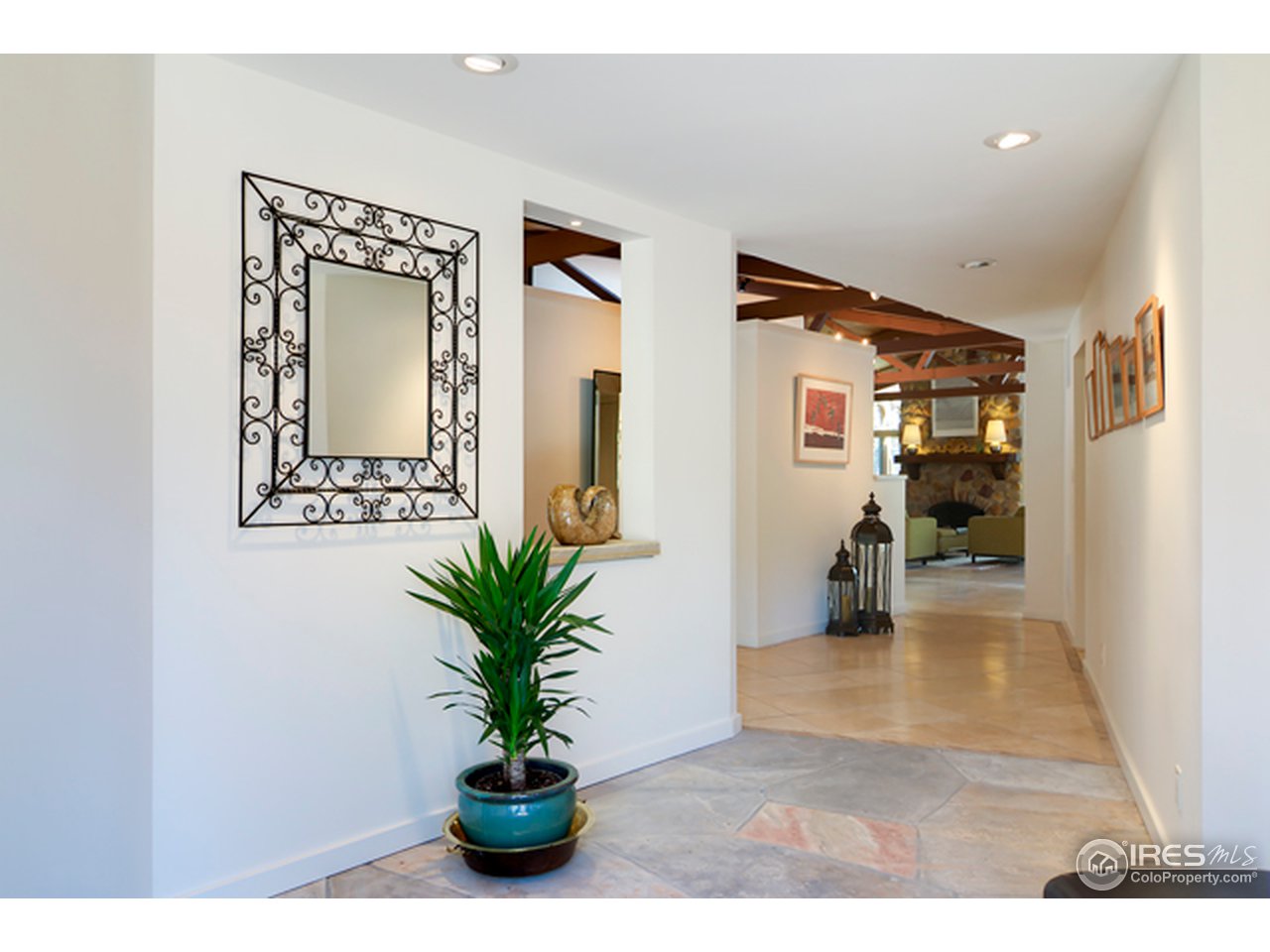 1270 Old Tale Road Boulder, CO 80303 - Photo 5 of 25 a view of a hallway with wooden floor and a living room