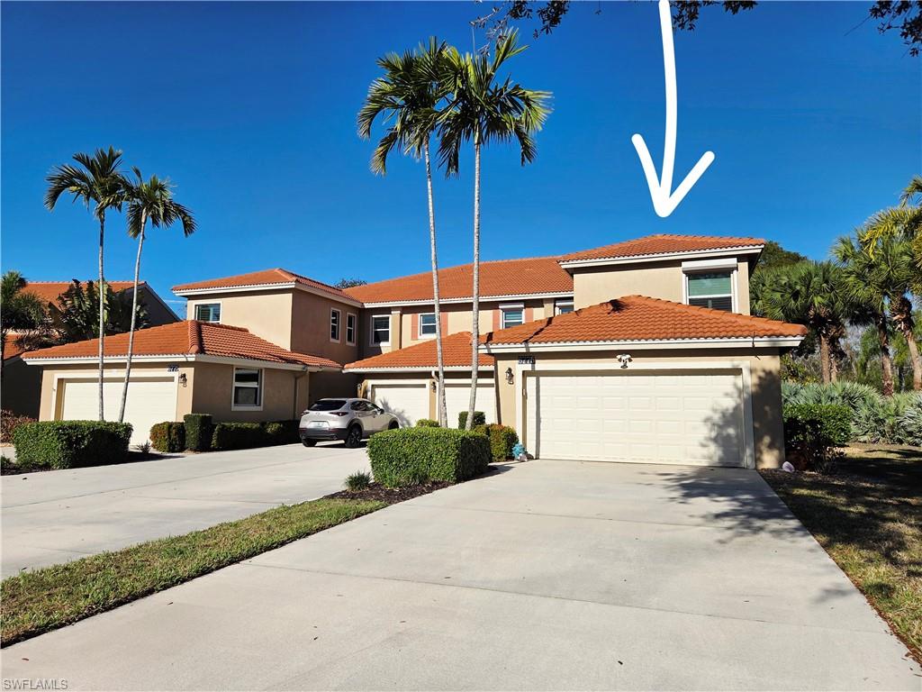 6775 Huntington Lakes Circle, Unit 202 Naples, FL 34119 - Photo 1 of 46 a front view of a house with a yard