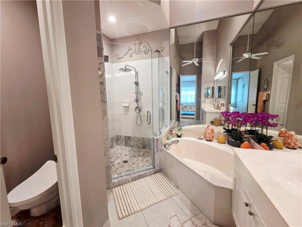 6775 Huntington Lakes Circle, Unit 202 Naples, FL 34119 - Photo 12 of 46 a bathroom with a sink mirror toilet and shower