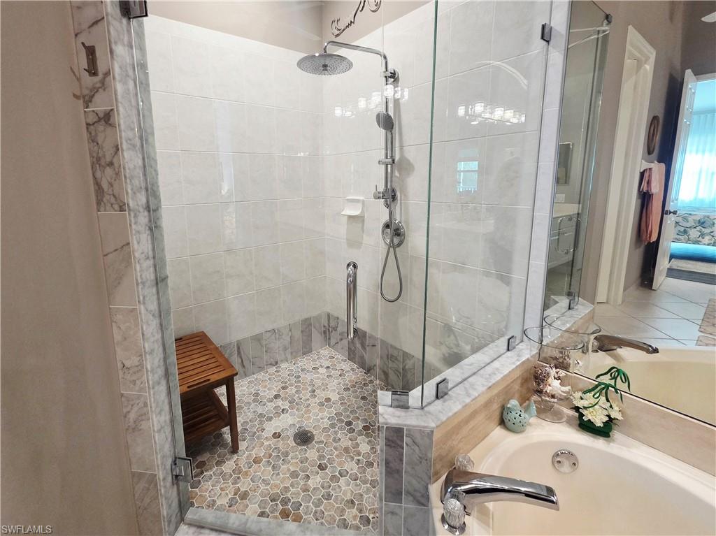 6775 Huntington Lakes Circle, Unit 202 Naples, FL 34119 - Photo 13 of 46 a bathroom with a sink and a mirror
