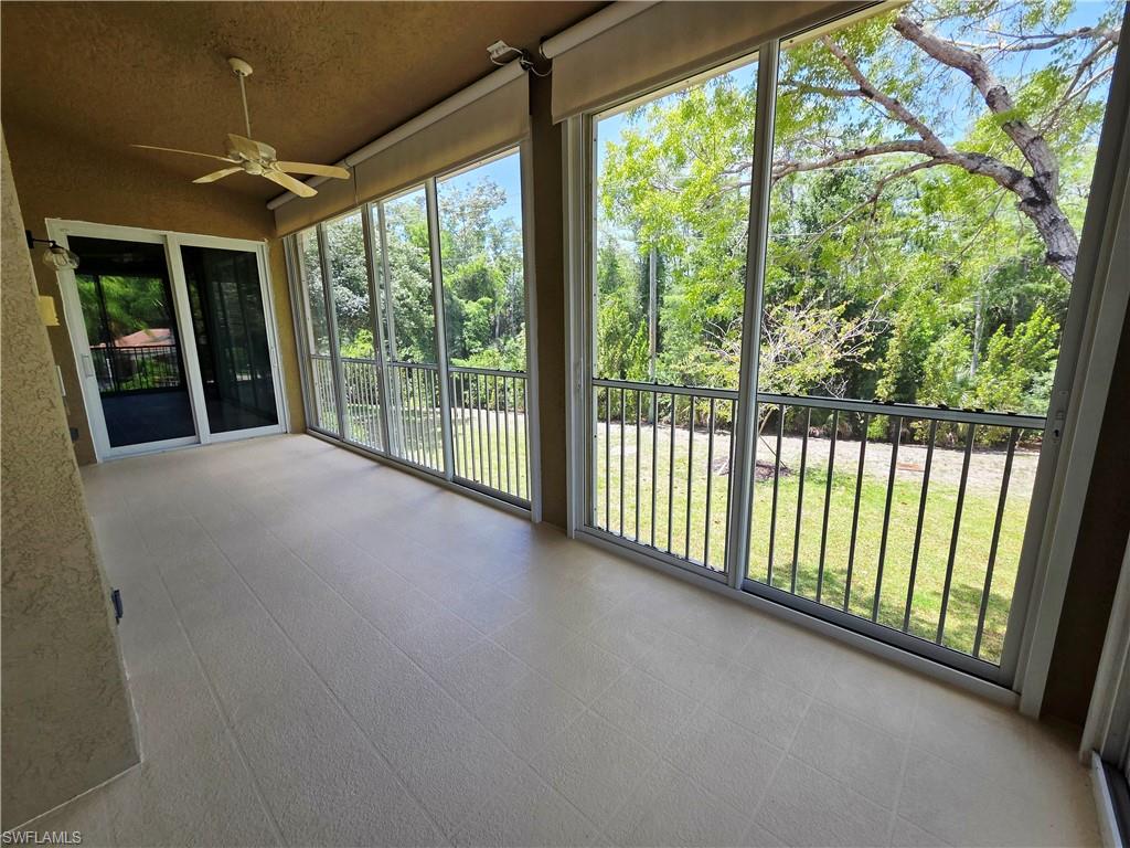 6775 Huntington Lakes Circle, Unit 202 Naples, FL 34119 - Photo 14 of 46 a view of a room with large windows and furniture