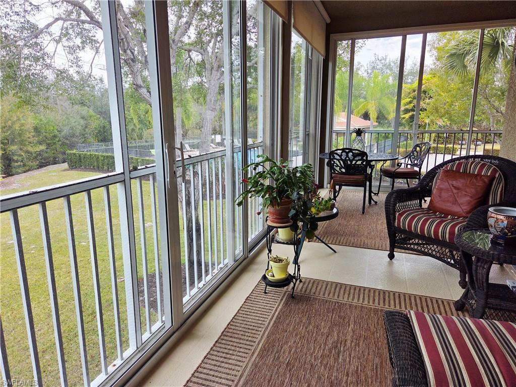 6775 Huntington Lakes Circle, Unit 202 Naples, FL 34119 - Photo 16 of 46 a balcony with furniture and wooden floor