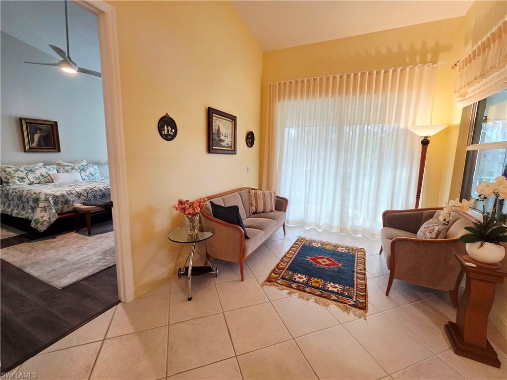 6775 Huntington Lakes Circle, Unit 202 Naples, FL 34119 - Photo 19 of 46 a living room with furniture and a window