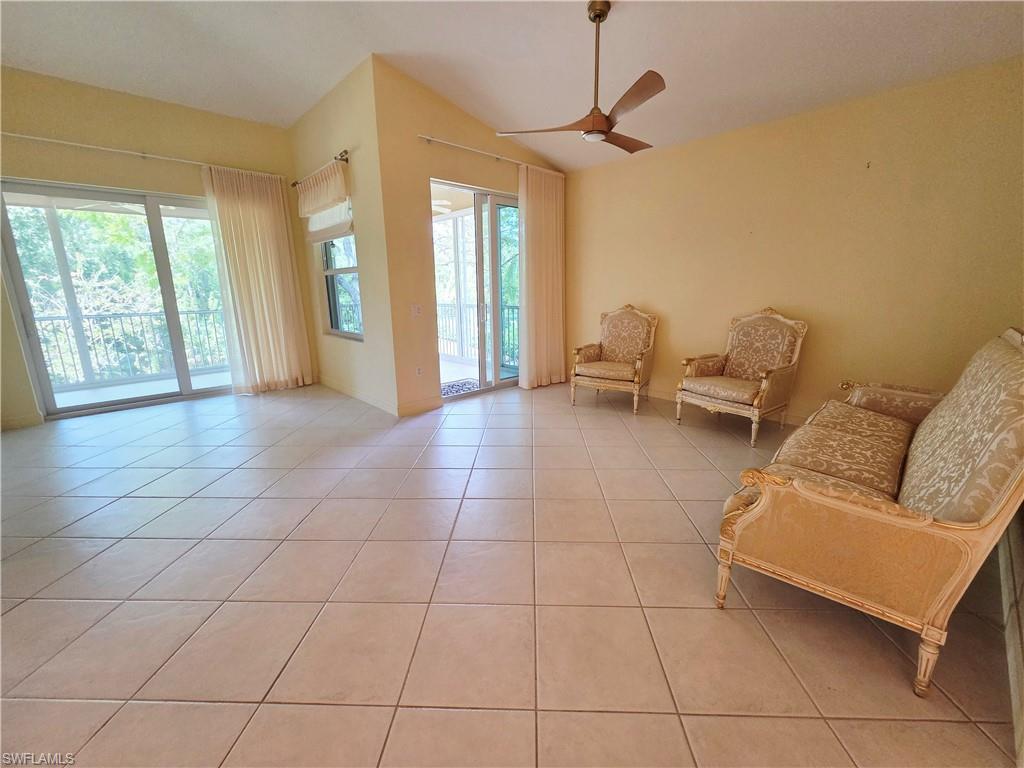 6775 Huntington Lakes Circle, Unit 202 Naples, FL 34119 - Photo 20 of 46 a living room with couches and large windows