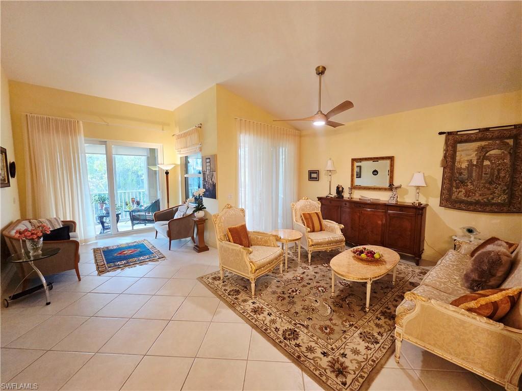 6775 Huntington Lakes Circle, Unit 202 Naples, FL 34119 - Photo 21 of 46 a living room with furniture and a large window