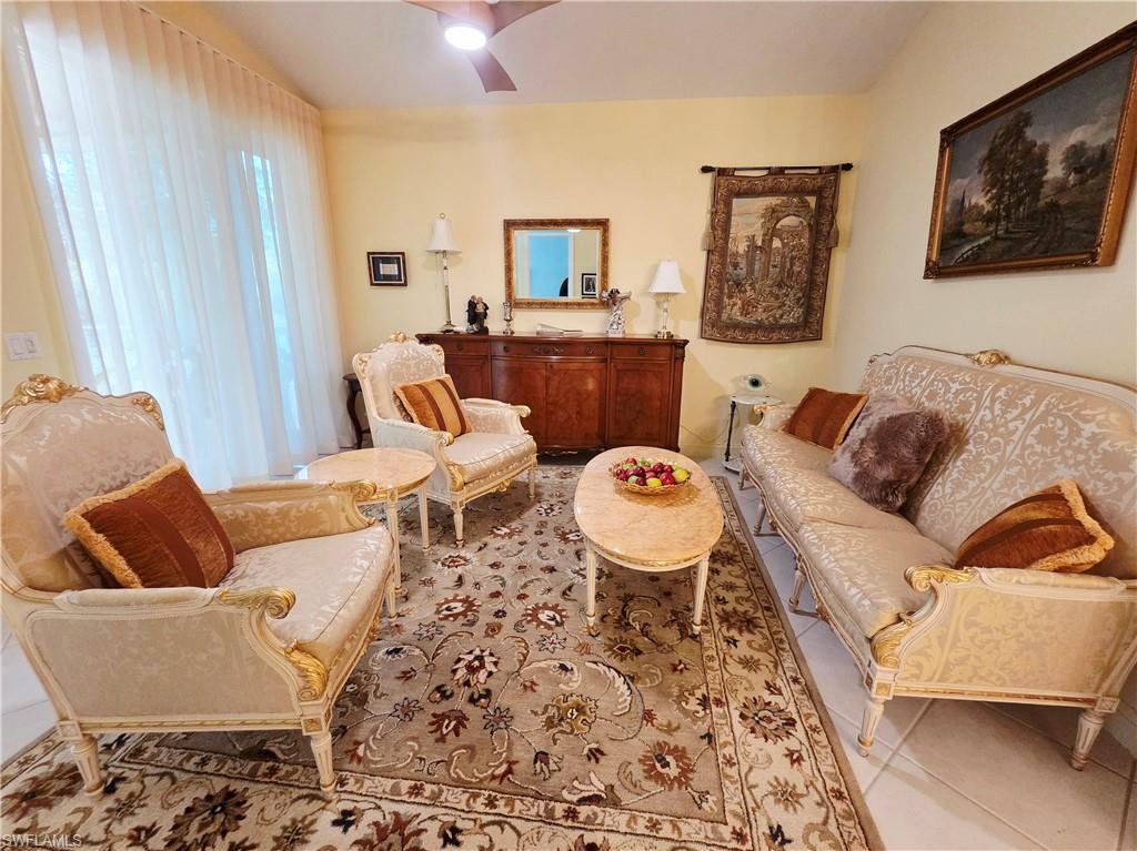 6775 Huntington Lakes Circle, Unit 202 Naples, FL 34119 - Photo 24 of 46 a living room with furniture and a rug