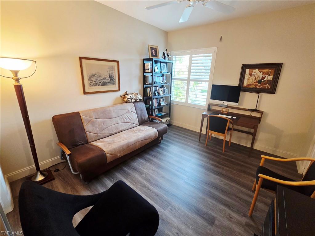 6775 Huntington Lakes Circle, Unit 202 Naples, FL 34119 - Photo 27 of 46 a living room with furniture and a wooden floor